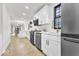 Updated kitchen boasts stainless appliances, white cabinets, and a kitchen island at 15 N Campbell Ave, Indianapolis, IN 46219