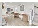 Bright living room features light wood flooring, neutral paint, modern furniture, and large windows at 15 N Campbell Ave, Indianapolis, IN 46219