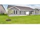Backyard with a large green lawn, concrete patio, and gray siding at 17066 Cole Evans Dr, Noblesville, IN 46060