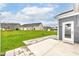 Backyard with a large green lawn, concrete patio, and view of neighboring houses at 17066 Cole Evans Dr, Noblesville, IN 46060