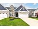 Charming home with stone details, a blue exterior, and a well-manicured lawn at 17066 Cole Evans Dr, Noblesville, IN 46060