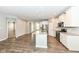 Modern kitchen with white cabinets, stainless steel appliances, a large island, and hardwood floors at 17066 Cole Evans Dr, Noblesville, IN 46060