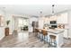 Spacious kitchen with white cabinetry, stainless steel appliances, a large island, and adjacent dining area at 17066 Cole Evans Dr, Noblesville, IN 46060