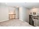 View of a finished loft space with carpet and railing at 17066 Cole Evans Dr, Noblesville, IN 46060