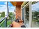 Outdoor balcony seating area with charming decor and an open sliding door to the condo interior at 20971 Shoreline Ct # 306, Noblesville, IN 46062