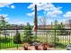Outdoor patio with railing overlooking a waterfront view, complete with potted colorful flowers at 20971 Shoreline Ct # 306, Noblesville, IN 46062