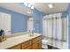 Bathroom with blue walls featuring a shower and tub combo and a large mirror at 20971 Shoreline Ct # 306, Noblesville, IN 46062