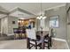 Dining area with modern chandelier, table with seating for four, and bar seating in the kitchen at 20971 Shoreline Ct # 306, Noblesville, IN 46062