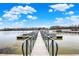 Wooden dock leading to boat slips and docks, under a clear sky with fluffy clouds at 20971 Shoreline Ct # 306, Noblesville, IN 46062