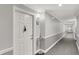 Neutral-toned hallway with carpeting, crown molding and baseboards with door leading to unit 306 at 20971 Shoreline Ct # 306, Noblesville, IN 46062