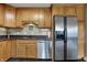 Kitchen with stainless steel appliances, granite countertops, and natural wood cabinets at 20971 Shoreline Ct # 306, Noblesville, IN 46062