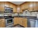 Well-lit kitchen featuring stainless steel appliances, granite countertops, and custom wooden cabinetry at 20971 Shoreline Ct # 306, Noblesville, IN 46062