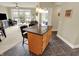 Kitchen island featuring dark countertops, modern cabinetry, and bar stool seating open to the living space at 20971 Shoreline Ct # 306, Noblesville, IN 46062