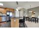 Kitchen with stainless steel appliances, island with breakfast bar and adjacent dining area, creating a cozy flow at 20971 Shoreline Ct # 306, Noblesville, IN 46062