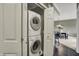 Laundry closet with stacked washer and dryer, with a dining area visible in the background at 20971 Shoreline Ct # 306, Noblesville, IN 46062