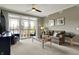 Comfortable living room with ceiling fan and access to the outdoor balcony with beautiful views at 20971 Shoreline Ct # 306, Noblesville, IN 46062