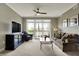 Comfortable living room with entertainment center, ceiling fan, and access to the outdoor balcony at 20971 Shoreline Ct # 306, Noblesville, IN 46062