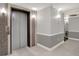 Condo lobby featuring an elevator and neutral paint palette with elegant wall sconces at 20971 Shoreline Ct # 306, Noblesville, IN 46062