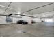 Well-lit parking garage with multiple parking spots and visible electrical panels and ventilation at 20971 Shoreline Ct # 306, Noblesville, IN 46062