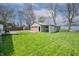 Spacious backyard featuring green grass, an old deck, and the detached garage at 218 E Mechanic St, Shelbyville, IN 46176