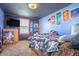 Bedroom featuring a bed, dresser, window, and blue accent walls with hanging anime posters at 218 E Mechanic St, Shelbyville, IN 46176