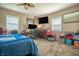 Bedroom features a bed, two monitors, and a ceiling fan at 218 E Mechanic St, Shelbyville, IN 46176