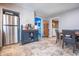 A kitchen with stainless steel refrigerator and appliances flowing into a laundry and dining area at 218 E Mechanic St, Shelbyville, IN 46176