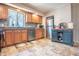 Bright kitchen featuring oak cabinets, stainless steel appliances, tile backsplash and flooring, under cabinet lighting at 218 E Mechanic St, Shelbyville, IN 46176