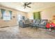 Inviting living room featuring comfortable seating, neutral walls and carpet, and an abundance of natural light at 218 E Mechanic St, Shelbyville, IN 46176