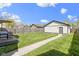 Spacious backyard with lush lawn, detached garage, and a charming deck area for outdoor living at 2225 Alabama St, Indianapolis, IN 46205