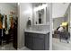 Bathroom featuring a gray vanity with granite counter and convenient closet access at 2225 Alabama St, Indianapolis, IN 46205