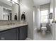Bright bathroom features a granite vanity, and shower with subway tile at 2225 Alabama St, Indianapolis, IN 46205