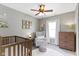 Well-decorated Bedroom with crib, armchair, and neutral colors at 2225 Alabama St, Indianapolis, IN 46205