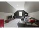 Finished attic bonus room with a comfy, oversized sectional and a modern entertainment setup at 2225 Alabama St, Indianapolis, IN 46205