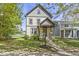 Inviting two-story house with charming porch, well-kept lawn, and detailed trim, creating a warm and attractive facade at 2225 Alabama St, Indianapolis, IN 46205
