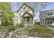 Charming two-story home boasts a welcoming front porch, manicured lawn, and beautiful landscaping, showcasing curb appeal at 2225 Alabama St, Indianapolis, IN 46205