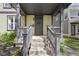 Inviting front porch with stylish gray accents and well manicured landscaping at 2225 Alabama St, Indianapolis, IN 46205