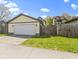 A detached two car garage provides ample space for parking and storage with a well-kept lawn at 2225 Alabama St, Indianapolis, IN 46205
