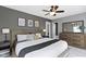 Comfortable main bedroom with king bed, ceiling fan, and ensuite bathroom at 2225 Alabama St, Indianapolis, IN 46205