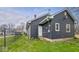 Back of house with grassy yard, small deck, and exterior door at 2349 Indianapolis Ave, Indianapolis, IN 46208