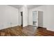 Empty bedroom with wood floors and a partially open doorway at 2349 Indianapolis Ave, Indianapolis, IN 46208