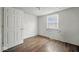 This bedroom features hardwood floors, one window and a closet door at 2349 Indianapolis Ave, Indianapolis, IN 46208