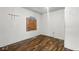 Vacant bedroom featuring wood-look floors and boarded-up window at 2349 Indianapolis Ave, Indianapolis, IN 46208