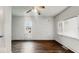 Well-lit bedroom with hardwood floors, a ceiling fan and freshly painted white walls at 2349 Indianapolis Ave, Indianapolis, IN 46208
