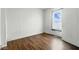 View of an empty bedroom with hardwood floors and a window at 2349 Indianapolis Ave, Indianapolis, IN 46208