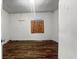Vacant bedroom featuring wood-look floors and boarded-up window at 2349 Indianapolis Ave, Indianapolis, IN 46208