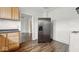 A refrigerator and wooden cabinets are pictured in the kitchen at 2349 Indianapolis Ave, Indianapolis, IN 46208