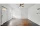 Bright living room with hardwood floors, ceiling fan, and a fresh coat of white paint at 2349 Indianapolis Ave, Indianapolis, IN 46208