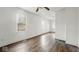 Bright living room with hardwood floors, a ceiling fan and freshly painted white walls at 2349 Indianapolis Ave, Indianapolis, IN 46208