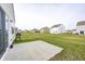Spacious backyard with a concrete patio and well-maintained lawn, perfect for outdoor gatherings at 238 Switchgrass Ln, New Whiteland, IN 46184